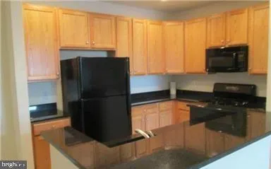 a kitchen with a refrigerator and a stove