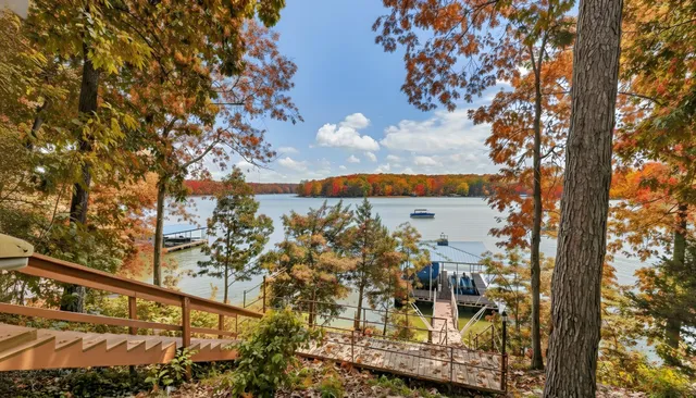 a roof deck with couches and wooden fence