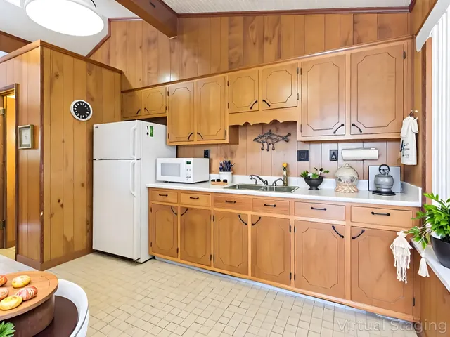 a kitchen with stainless steel appliances granite countertop a refrigerator sink and cabinets