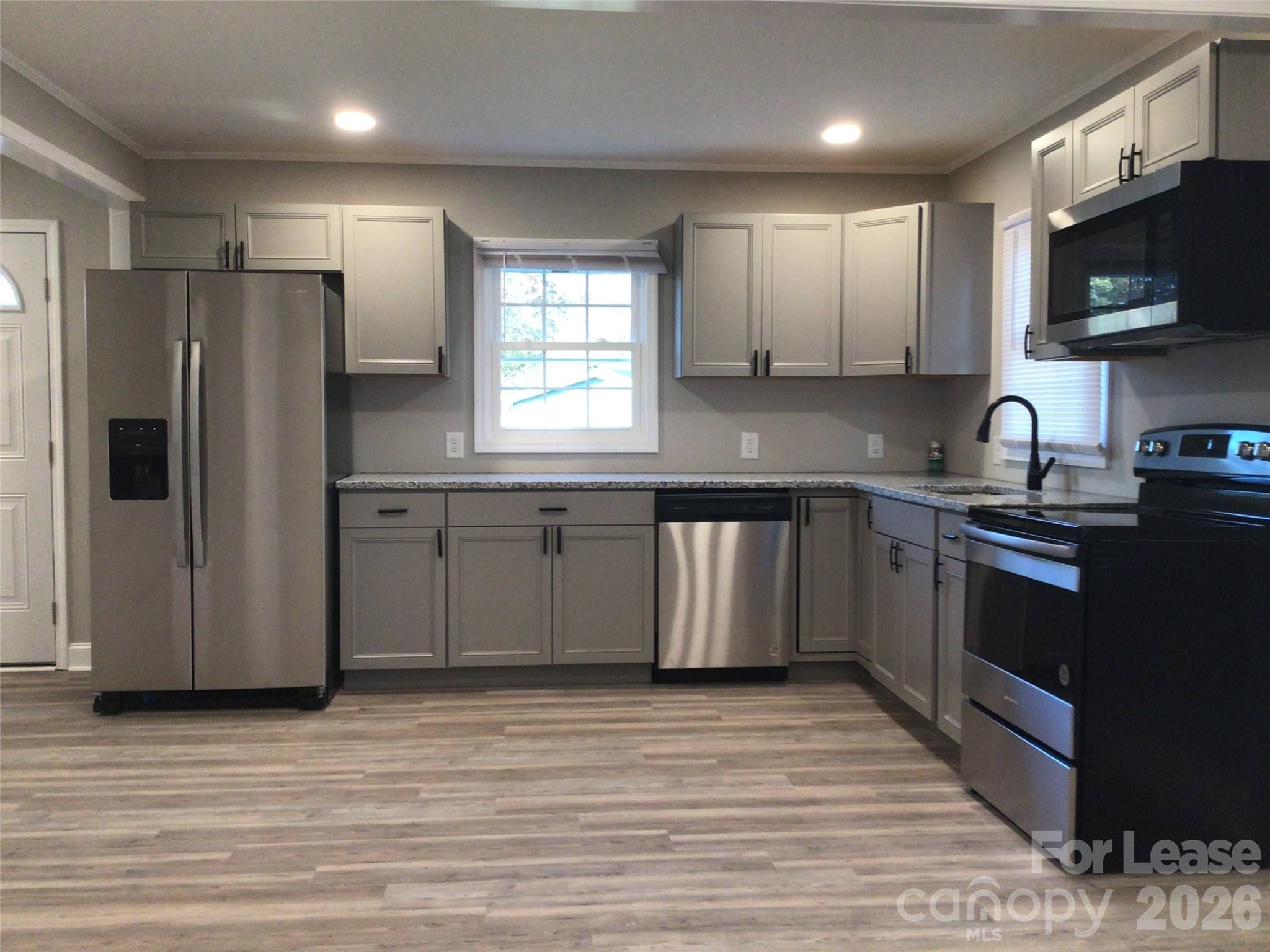 816 Margrace Road Kings Mountain, NC 28086 - Photo 4 of 13 a kitchen with stainless steel appliances granite countertop a refrigerator sink and microwave