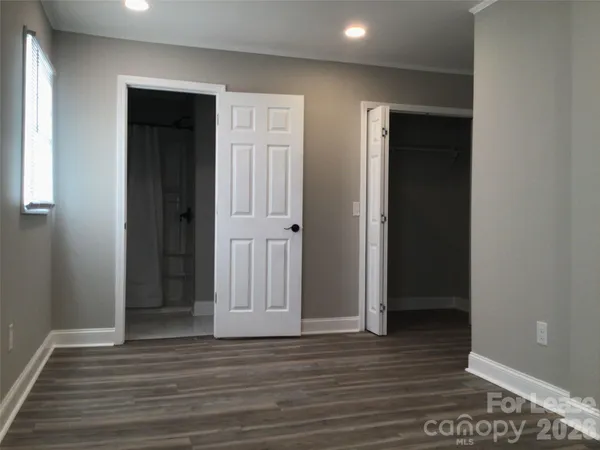 an empty room with wooden floor and closet