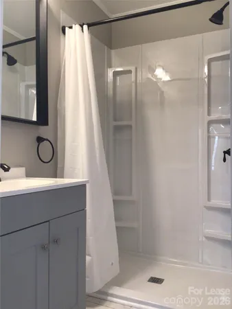 a bathroom with a shower and a sink