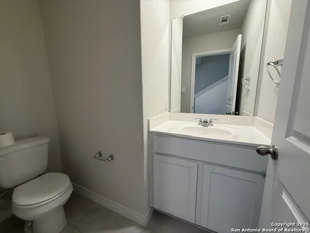 a view of an empty room with wooden floor and windows