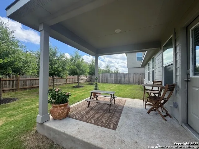 a view of a chair and tables in the patio