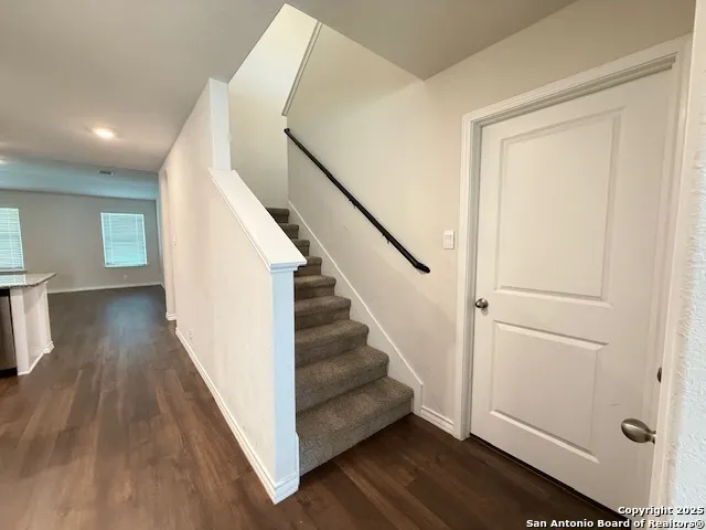 a kitchen with granite countertop white cabinets and stainless steel appliances