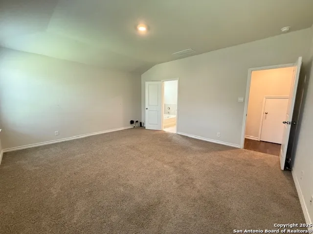 a spacious bathroom with a tub sink shower and mirror