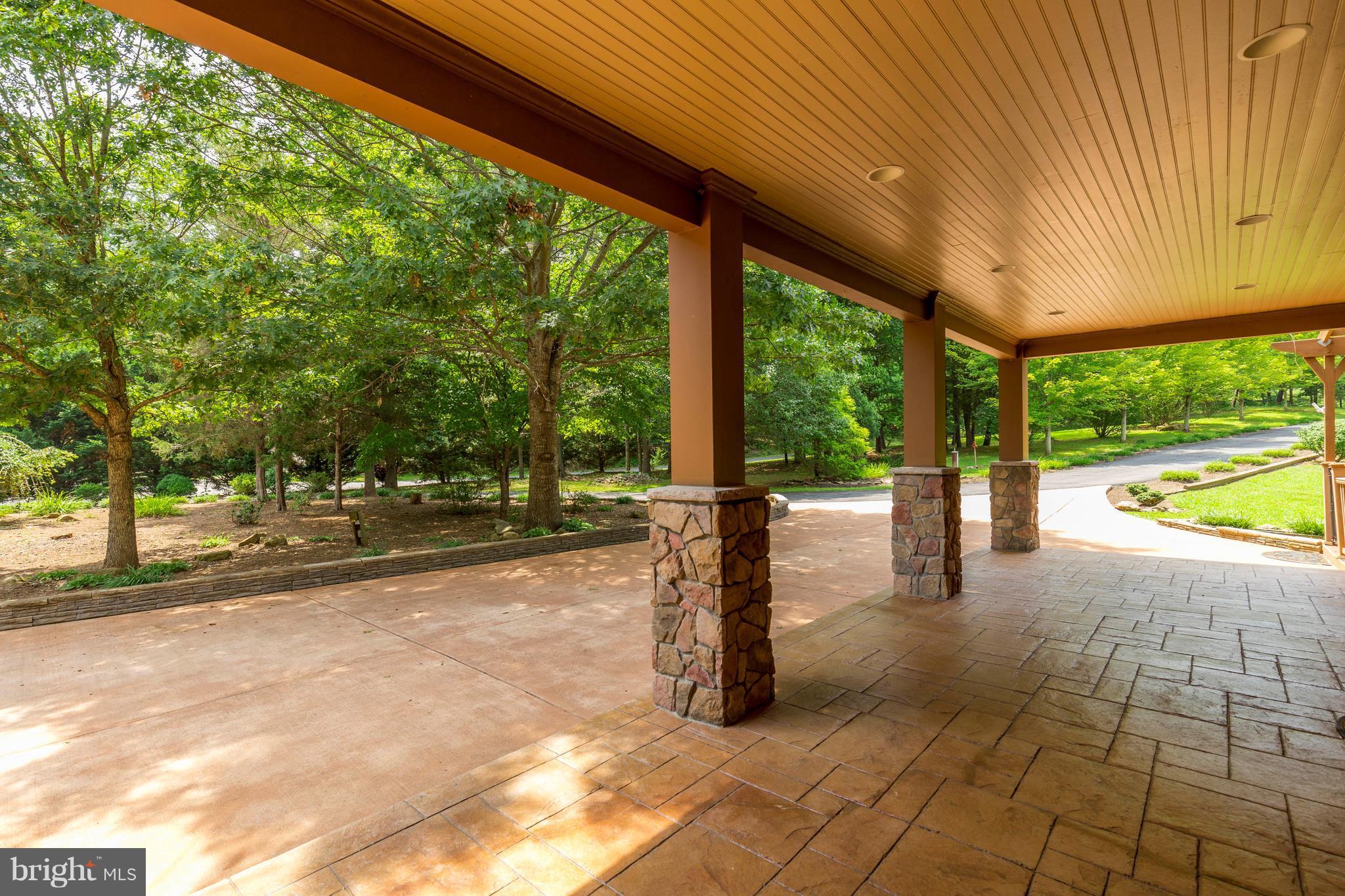 10242 Cliff Mills Road Marshall, VA 20115 - Photo 2 of 30 a view of a patio with a table and chairs next to a yard
