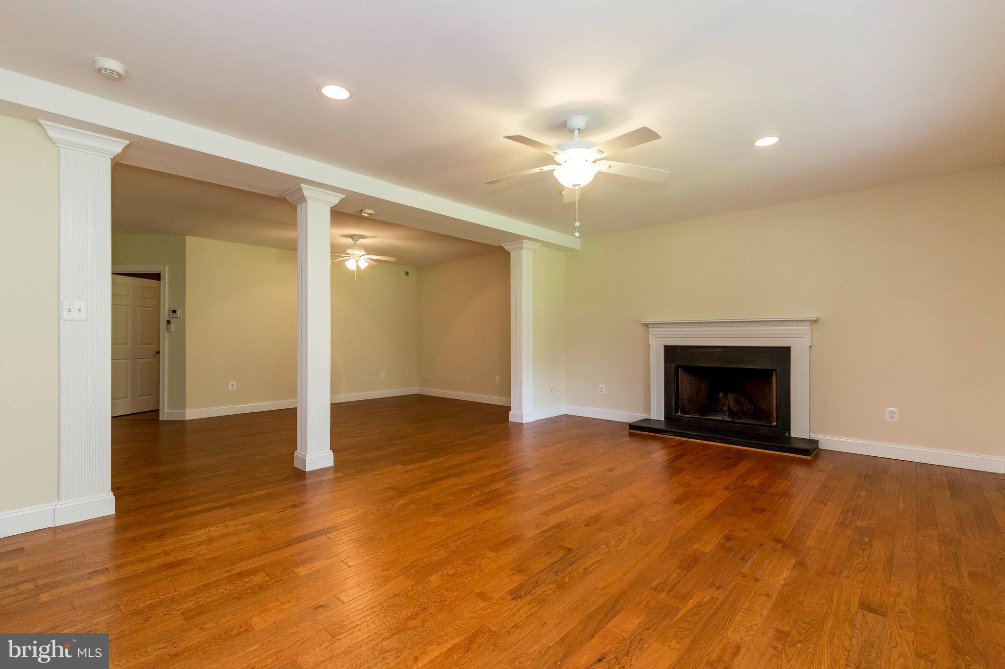 10242 Cliff Mills Road Marshall, VA 20115 - Photo 16 of 30 a view of an empty room with wooden floor and a fireplace