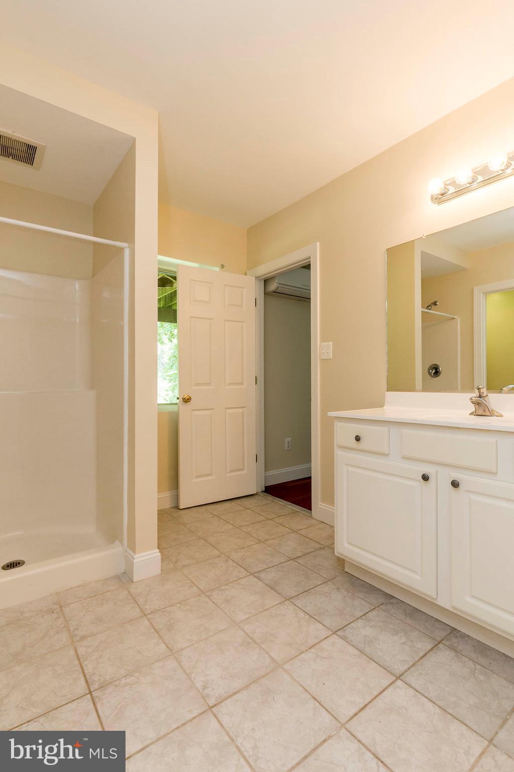10242 Cliff Mills Road Marshall, VA 20115 - Photo 17 of 30 a view of a bathroom with sink closet and mirror