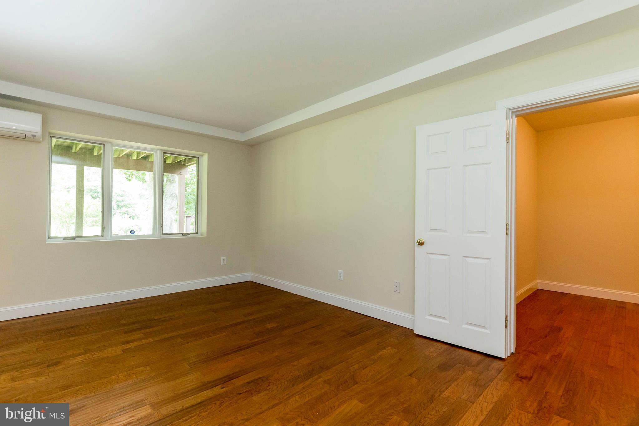 10242 Cliff Mills Road Marshall, VA 20115 - Photo 18 of 30 a view of an empty room with wooden floor and a window