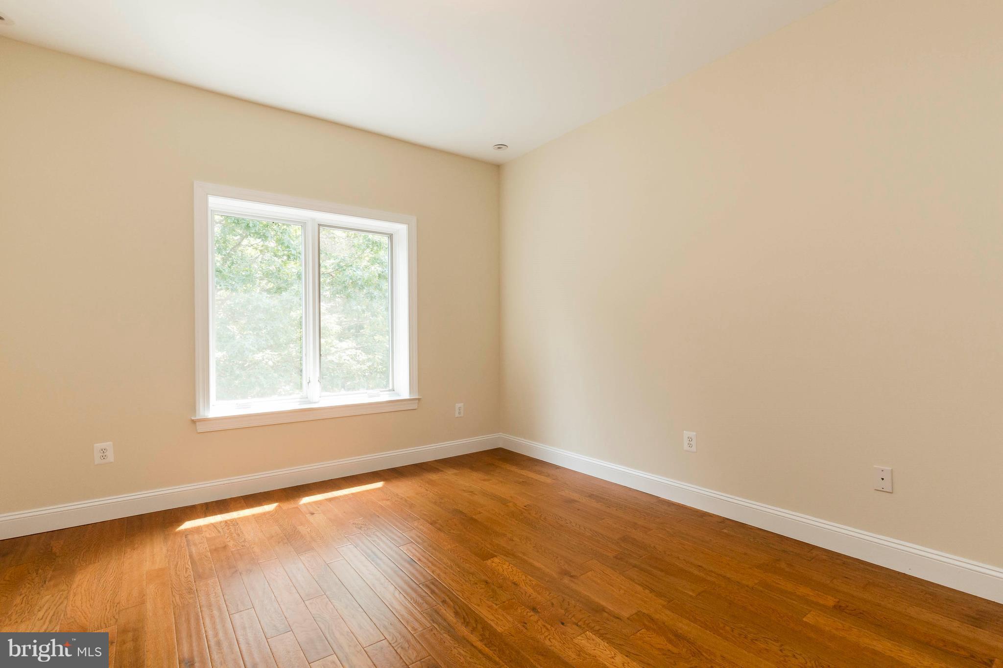10242 Cliff Mills Road Marshall, VA 20115 - Photo 19 of 30 an empty room with wooden floor and windows