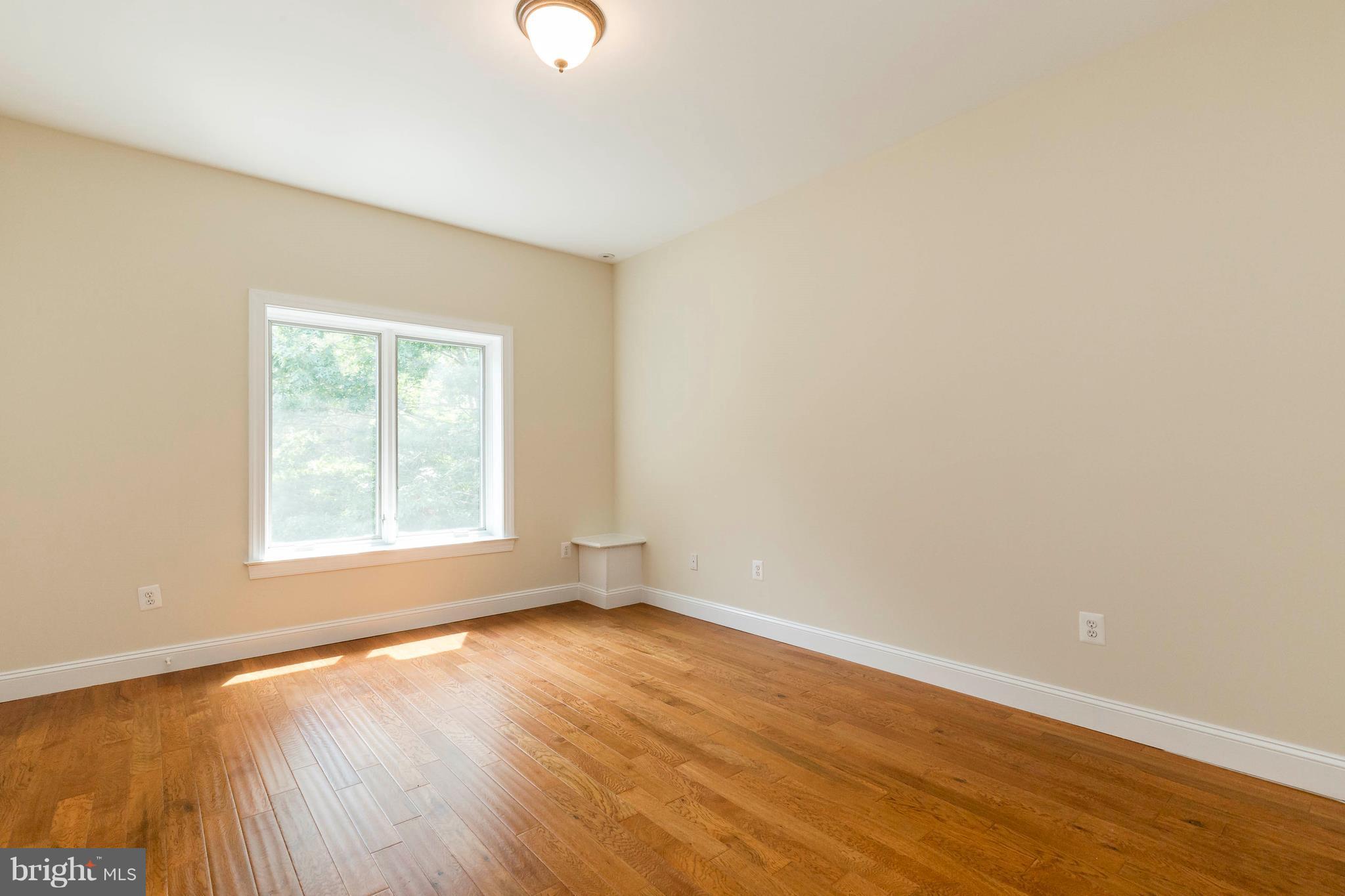 10242 Cliff Mills Road Marshall, VA 20115 - Photo 26 of 30 an empty room with wooden floor and windows