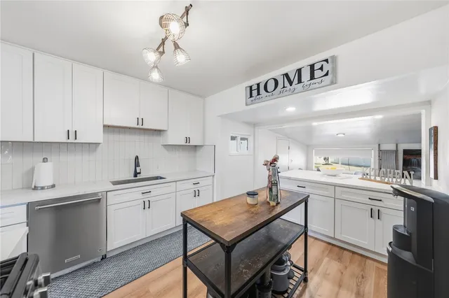 a kitchen with stainless steel appliances a stove sink microwave and cabinets