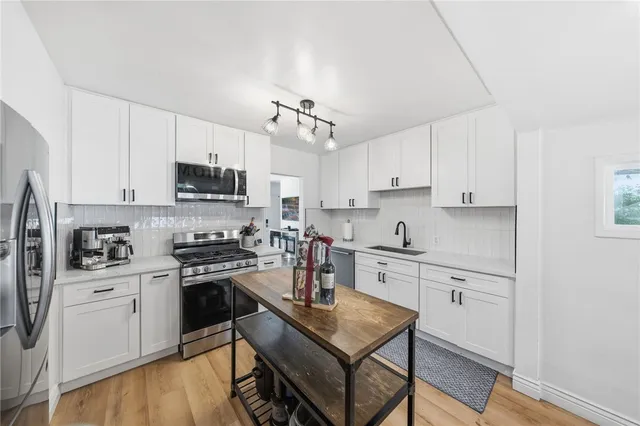 a kitchen with stainless steel appliances a refrigerator stove microwave and cabinets