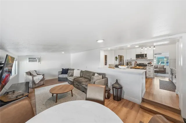 a bedroom with a bed couch and a flat screen tv