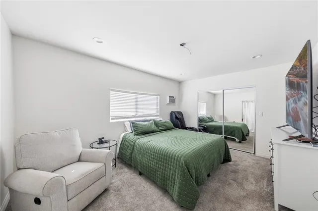 a bedroom with a bed and chair