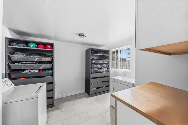 a view of a patio with table and chairs and potted plants