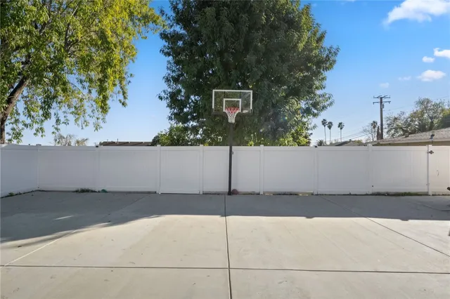 a front view of a house with a garden and trees
