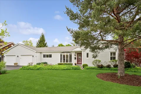 a view of a house with a backyard