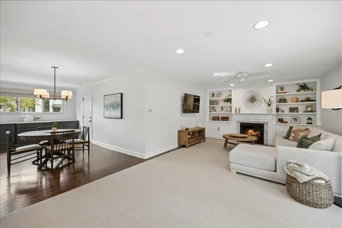 a living room with fireplace furniture and a wooden floor
