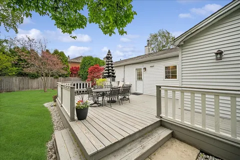 a view of a chairs and table on the wooden deck