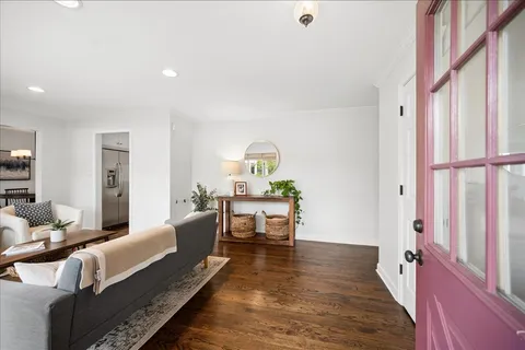 a bedroom with furniture and a wooden floor