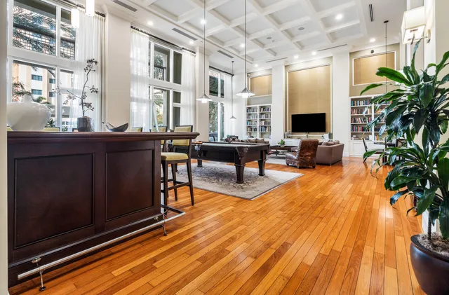a living room with furniture windows and wooden floor