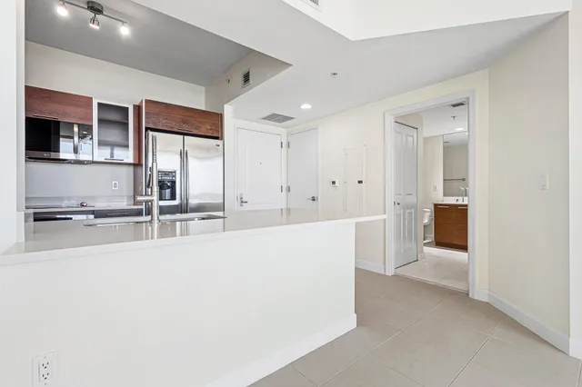 a view of a kitchen with a sink and cabinets