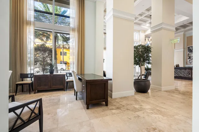 a living room with furniture and a potted plant
