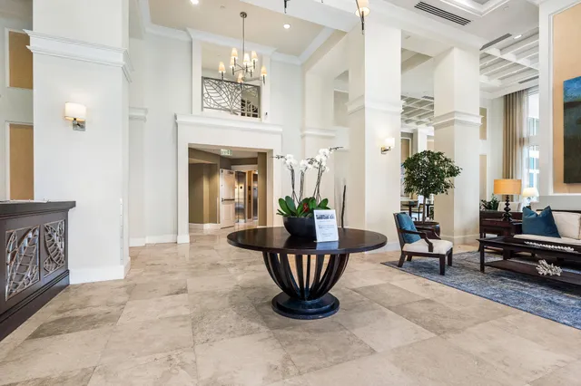 a living room with furniture a fireplace and potted plants