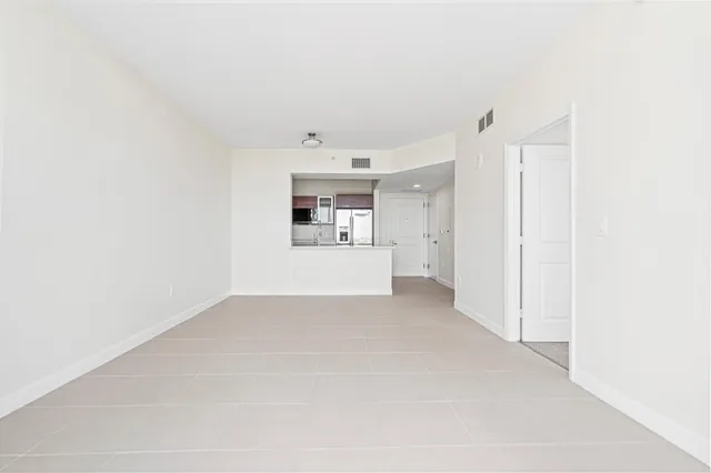 a view of a kitchen with a refrigerator and a sink