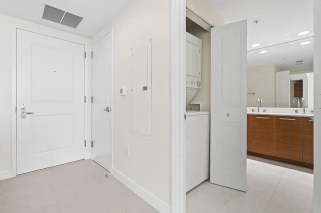 a view of a hallway with closet and utility room