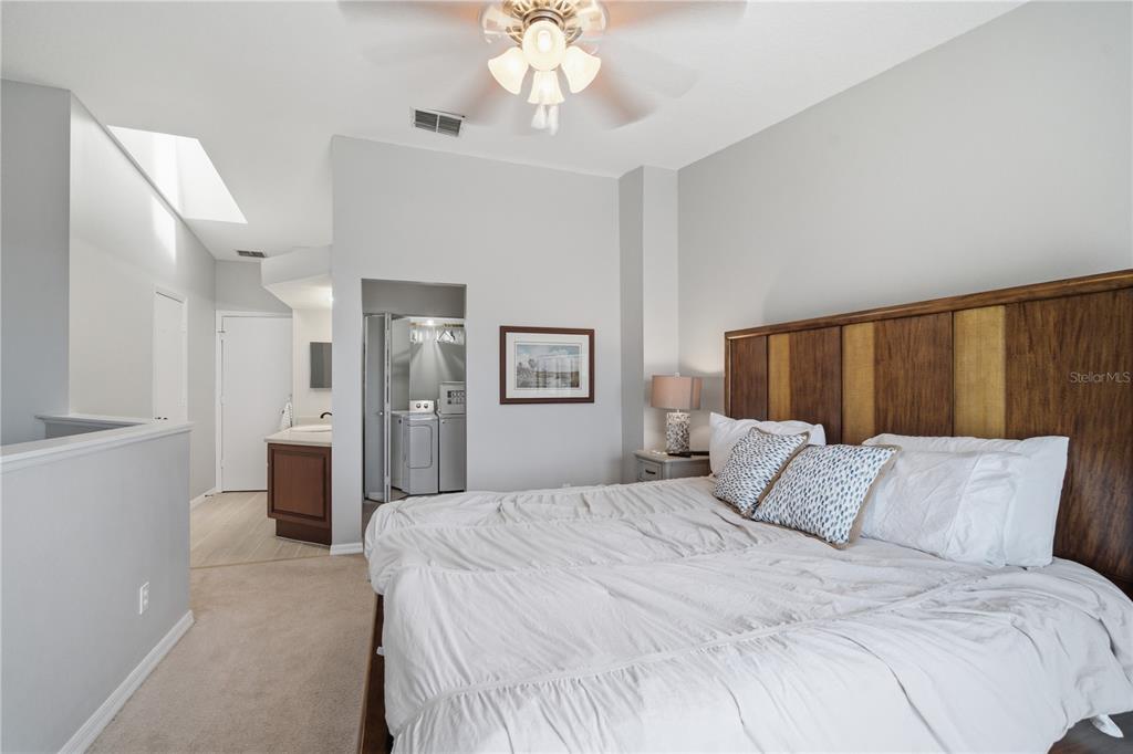 643 Garland Circle Indian Rocks Beach, FL 33785 - Photo 38 of 81 a bedroom with a large bed and a chandelier