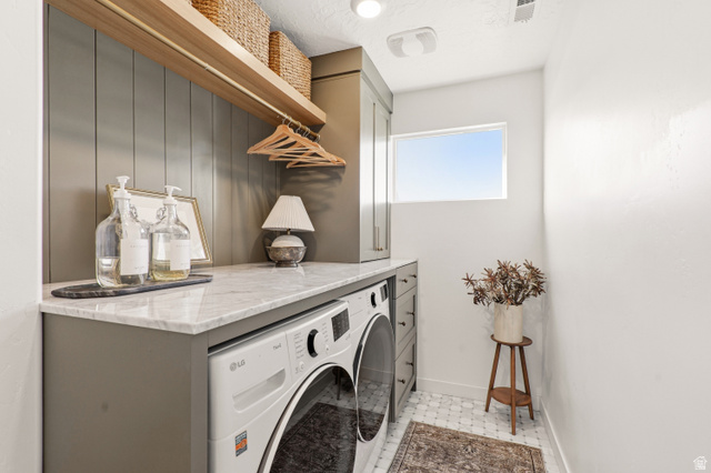 870 North Ada Loop Lehi, UT 84048 - Photo 34 of 51 Laundry area featuring a built-in countertop, integrated washer and dryer, wood-finish shelving, and overhead cabinetry