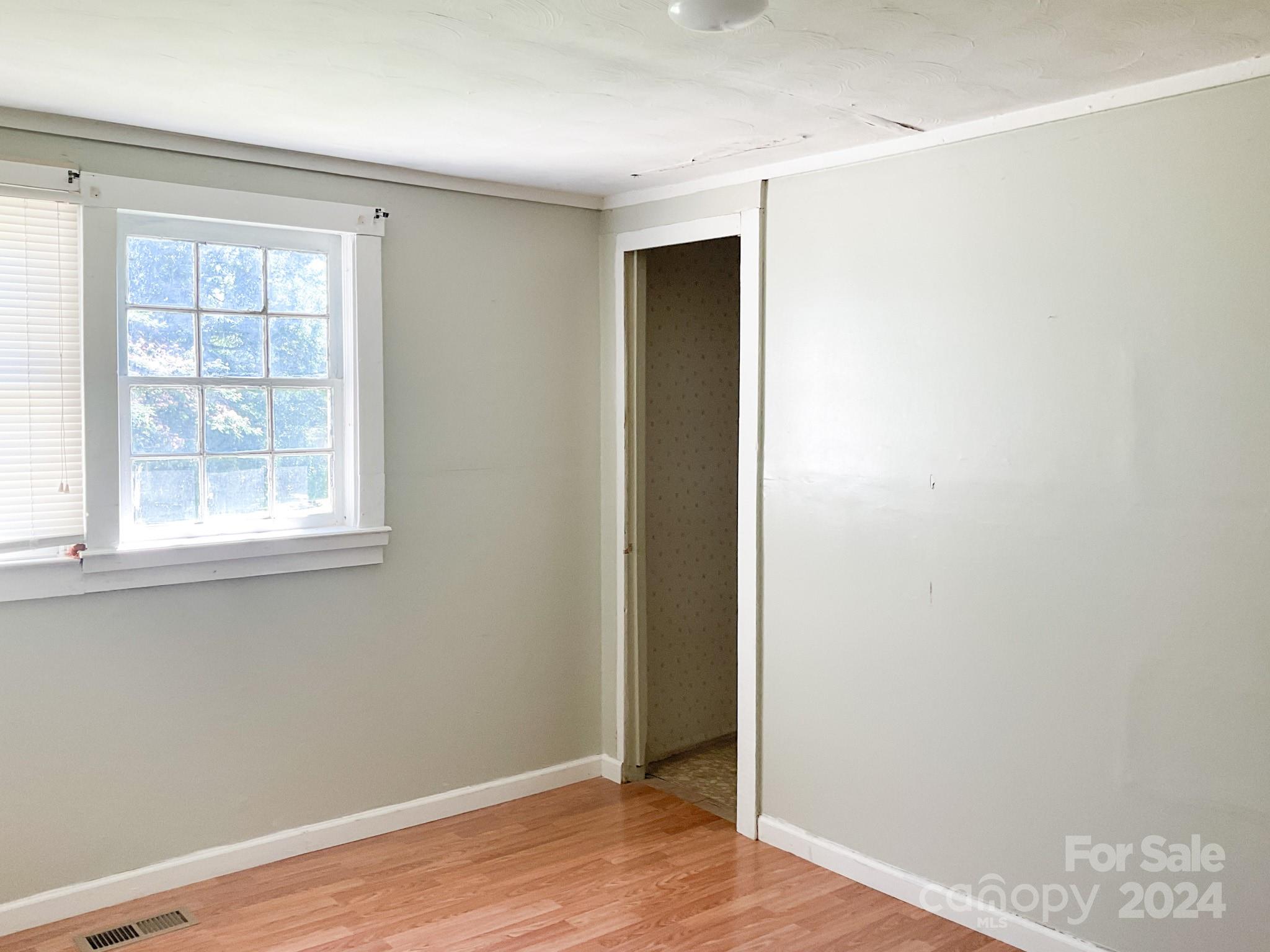 131 State Rd S-42-742 Wellford, SC 29385 - Photo 33 of 38 an empty room with wooden floor and windows
