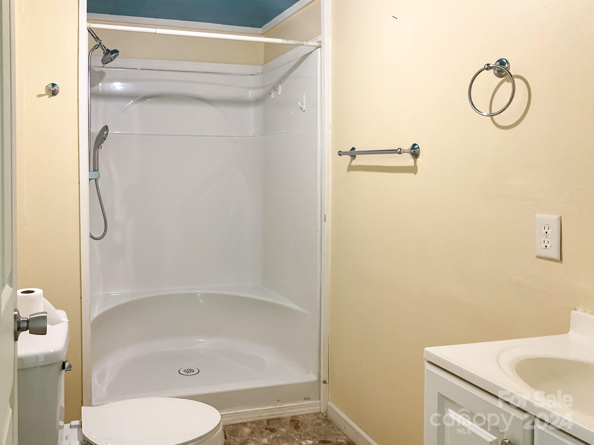 131 State Rd S-42-742 Wellford, SC 29385 - Photo 36 of 38 a bathroom with a granite countertop sink a toilet and shower