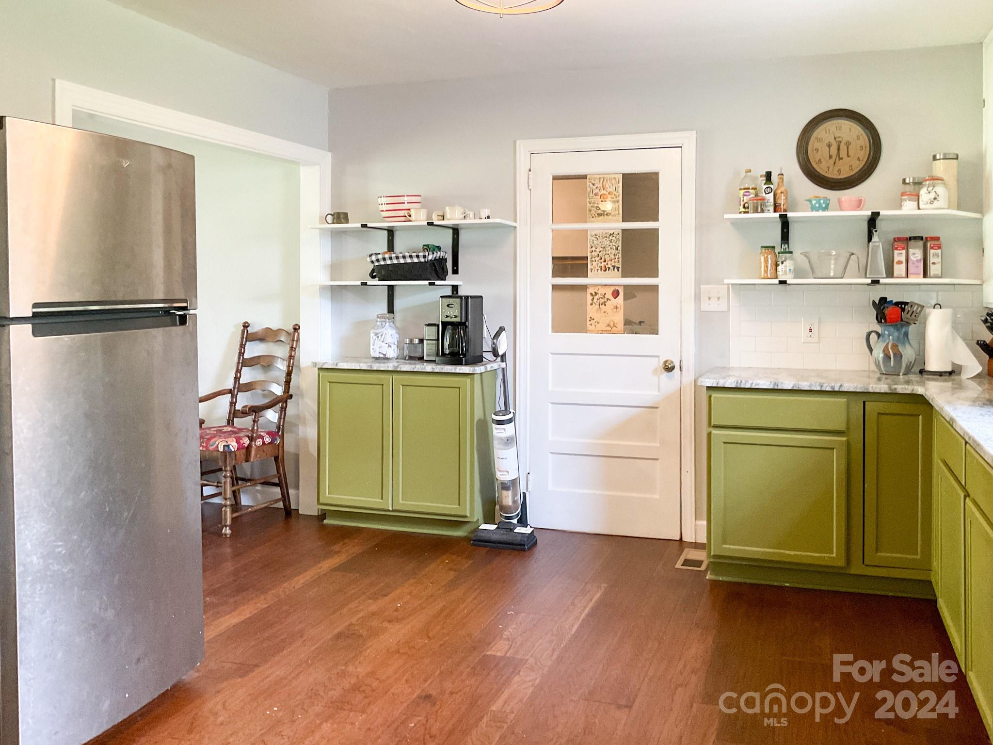 131 State Rd S-42-742 Wellford, SC 29385 - Photo 8 of 38 a room with a refrigerator and a wooden floor