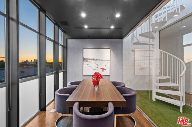 a dining room with furniture a rug and wooden floor
