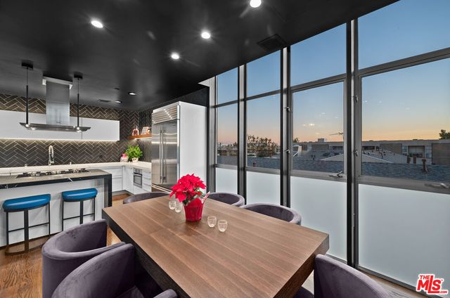 a view of a dining room with furniture and a potted plant