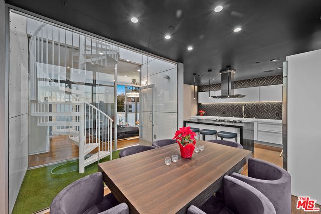 a kitchen with stainless steel appliances granite countertop a sink refrigerator and cabinets