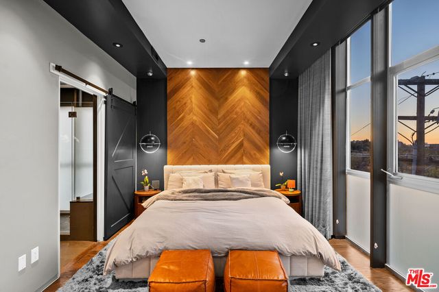 a bedroom with a bed and wooden floor
