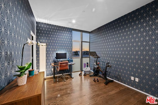 a view of a workspace with furniture and a potted plant