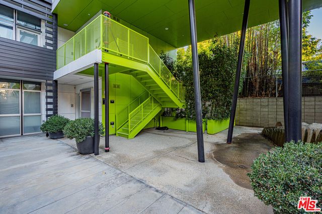a view of a path along with potted plants