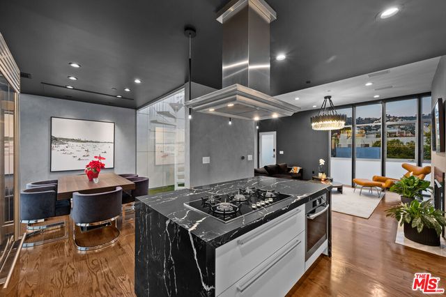 a kitchen that has a stove and a table in it