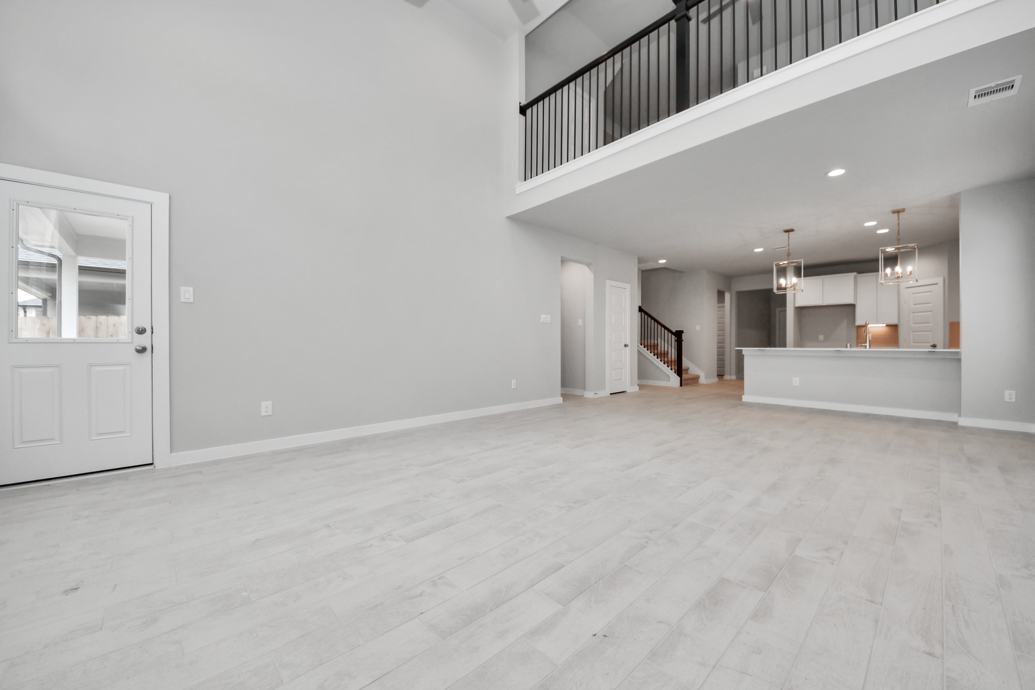 2946 Burris Park Drive Spring, TX 77373 - Photo 21 of 45 Bring your loved ones and guests together in the inviting living room! Boasting lofty high ceilings, recessed lighting, a stylish ceiling fan, custom paint, stunning flooring, and expansive windows that flood the space with ample natural light all day long.