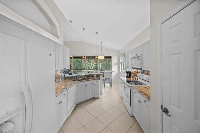 a kitchen with stainless steel appliances a sink and a refrigerator