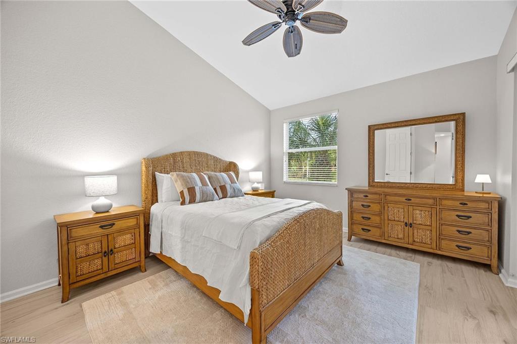 6864 Ascot Drive, Unit 5202 Naples, FL 34113 - Photo 18 of 36 a bedroom with a bed and a dresser
