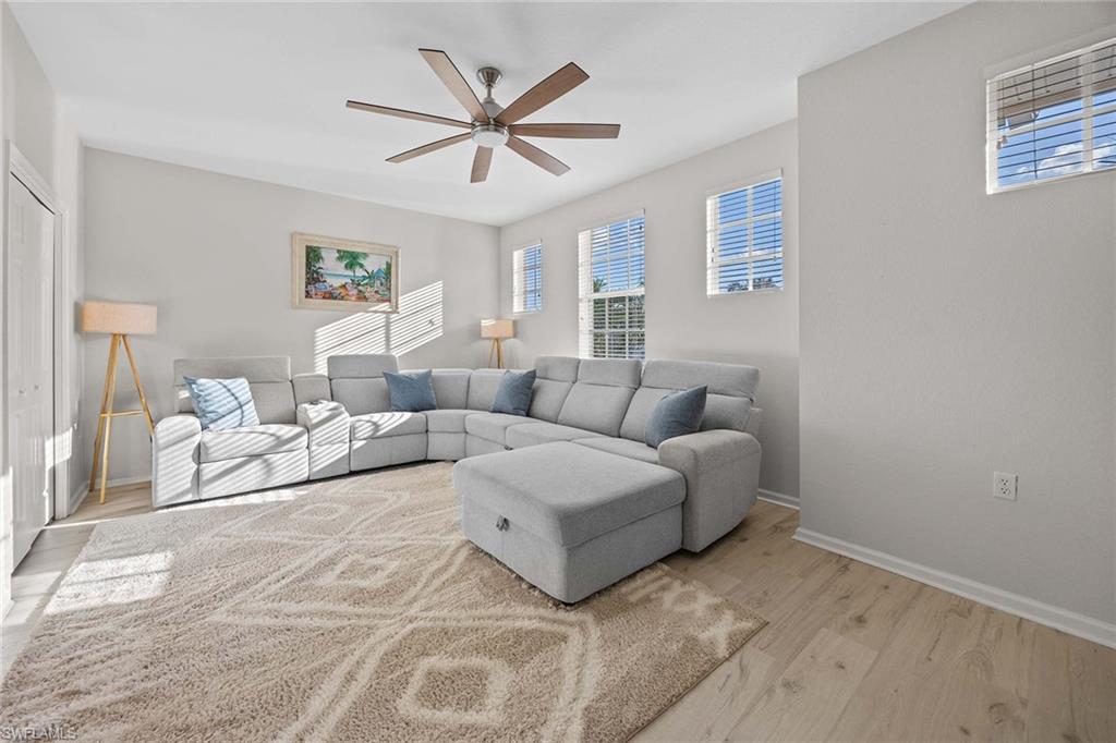 6864 Ascot Drive, Unit 5202 Naples, FL 34113 - Photo 23 of 36 a living room with furniture and a ceiling fan