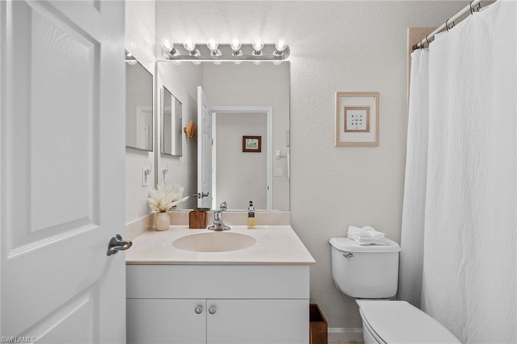 6864 Ascot Drive, Unit 5202 Naples, FL 34113 - Photo 25 of 36 a bathroom with a sink toilet and shower