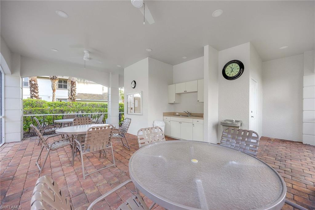 6864 Ascot Drive, Unit 5202 Naples, FL 34113 - Photo 32 of 36 a living room with furniture and a large window
